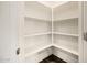 Bright walk-in pantry with white shelving perfect for organized storage at 611 W Crowned Dove Trl, Casa Grande, AZ 85122