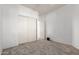 Cozy bedroom with neutral carpet, closet with white doors, and a connecting door at 702 S 119Th Ave, Avondale, AZ 85323