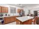 Bright kitchen with stainless steel appliances, white countertops, and a breakfast bar at 702 S 119Th Ave, Avondale, AZ 85323
