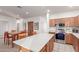 Well-lit kitchen with modern appliances, island, and an adjacent dining area, ideal for entertaining at 702 S 119Th Ave, Avondale, AZ 85323