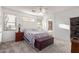 Serene main bedroom with carpet, ample natural light, and a view into the main bathroom at 702 S 119Th Ave, Avondale, AZ 85323