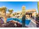 Inviting backyard pool with desert landscaping, covered patio and ample seating at 702 S 119Th Ave, Avondale, AZ 85323