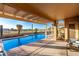 Covered patio overlooking a refreshing pool and expansive backyard view at 702 S 119Th Ave, Avondale, AZ 85323