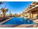 Inviting pool surrounded by desert landscaping and a covered patio area at 702 S 119Th Ave, Avondale, AZ 85323
