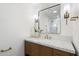 Stylish half-bathroom features modern fixtures, a marble countertop, and an elegant mirror with sconces at 7553 E Woodshire Cv, Scottsdale, AZ 85258