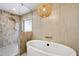 Elegant bathroom showcasing a standalone tub, separate shower, and modern design elements at 7553 E Woodshire Cv, Scottsdale, AZ 85258
