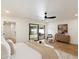 Bright primary bedroom with a ceiling fan, patio access, and contemporary decor for comfortable living at 7553 E Woodshire Cv, Scottsdale, AZ 85258