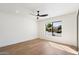 Bright, vacant bedroom with natural light from the window, hardwood floors, and ceiling fan at 7553 E Woodshire Cv, Scottsdale, AZ 85258