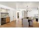 Dining room with a long table, wooden floors, a wine cooler, and an open floor plan at 7553 E Woodshire Cv, Scottsdale, AZ 85258