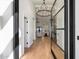 Bright entryway with hardwood floors, modern lighting, and views into the living room at 7553 E Woodshire Cv, Scottsdale, AZ 85258