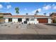 Well-maintained, single-story home with desert landscaping, a red tiled roof, and a two car garage at 7553 E Woodshire Cv, Scottsdale, AZ 85258