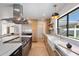 Modern kitchen with stainless steel appliances, a marble countertop, and custom cabinets at 7553 E Woodshire Cv, Scottsdale, AZ 85258