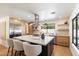 Modern kitchen with a large island, stainless steel appliances, and light wood cabinetry at 7553 E Woodshire Cv, Scottsdale, AZ 85258