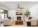Cozy living room featuring a fireplace, modern decor, and comfortable seating at 7553 E Woodshire Cv, Scottsdale, AZ 85258