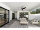 Stylish outdoor living area featuring comfortable seating, ceiling fan, and modern design at 7553 E Woodshire Cv, Scottsdale, AZ 85258