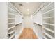 Well-organized walk-in closet with ample shelving and hanging space for efficient storage solutions at 7553 E Woodshire Cv, Scottsdale, AZ 85258