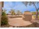 View of the backyard featuring a fireplace, water feature, desert landscaping, and seating area at 7654 W Congressional Way, Florence, AZ 85132