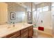 Elegant bathroom showcasing a double vanity, decorative wallpaper, and a tub with a shower at 7654 W Congressional Way, Florence, AZ 85132