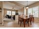 Open dining area featuring a wooden table with a view to the living room at 7654 W Congressional Way, Florence, AZ 85132