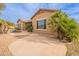 Exterior view of the property featuring desert landscaping, a water feature, and access to the backyard at 7654 W Congressional Way, Florence, AZ 85132