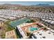 Community aerial view showcasing tennis courts, pool area, and residential homes with mountain backdrop at 7750 E Broadway Rd # 475, Mesa, AZ 85208