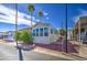 A charming home with a covered carport and an orange tree in the front yard at 7750 E Broadway Rd # 475, Mesa, AZ 85208