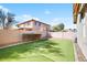 The private backyard features a grassy lawn, mature shrubs, and a block wall to ensure privacy at 8385 W Vogel Ave, Peoria, AZ 85345