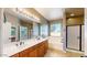 Bright bathroom featuring a double vanity, a soaking tub, and a tiled floor at 8385 W Vogel Ave, Peoria, AZ 85345