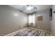 Bedroom with tiled floors, ceiling fan and light, and one window with curtains at 8385 W Vogel Ave, Peoria, AZ 85345