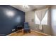 Bedroom with tiled floors, one window, and a charming blue rocking chair at 8385 W Vogel Ave, Peoria, AZ 85345