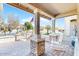 Relaxing front porch with stone pillars and a comfortable seating area, perfect for enjoying the outdoors at 8385 W Vogel Ave, Peoria, AZ 85345