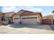 Single-story home featuring a spacious three-car garage and mature landscaping at 8385 W Vogel Ave, Peoria, AZ 85345