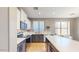 Spacious kitchen featuring stainless steel appliances, an island, granite countertops, and tiled floors at 8385 W Vogel Ave, Peoria, AZ 85345