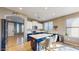 Beautiful kitchen featuring an island, tiled floors, white cabinets, and granite countertops at 8385 W Vogel Ave, Peoria, AZ 85345