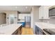 Bright kitchen featuring a stainless steel refrigerator, island, and tiled floors at 8385 W Vogel Ave, Peoria, AZ 85345
