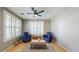 Cozy living room featuring shuttered windows, tile flooring, a ceiling fan, and comfortable seating at 8385 W Vogel Ave, Peoria, AZ 85345