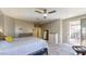 Spacious main bedroom featuring a ceiling fan, carpet flooring, and access to an outdoor patio at 8385 W Vogel Ave, Peoria, AZ 85345