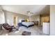Comfortable main bedroom featuring a ceiling fan, a seating area, and carpet flooring at 8385 W Vogel Ave, Peoria, AZ 85345