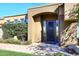 Close-up of a home's elegant front entrance with a decorative glass door and desert landscaping at 8514 E Krail St, Scottsdale, AZ 85250