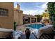 Relaxing backyard with comfortable chaise lounges, pool, covered patio, and manicured landscaping at 8737 E San Vicente Dr, Scottsdale, AZ 85258