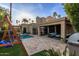 Stunning backyard oasis with pool, covered patio, mature landscaping, and a charming swing set at 8737 E San Vicente Dr, Scottsdale, AZ 85258