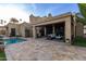 Expansive backyard featuring a pool, covered patio, and lush greenery for outdoor enjoyment at 8737 E San Vicente Dr, Scottsdale, AZ 85258