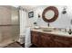 Well-lit bathroom featuring a decorative mirror and a glass-enclosed shower at 8737 E San Vicente Dr, Scottsdale, AZ 85258