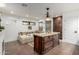 This bathroom has a large soaking tub and vanity island with granite countertops and dark wood cabinetry at 8737 E San Vicente Dr, Scottsdale, AZ 85258