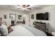 Bedroom with dark wood floors, an ensuite bathroom, and a modern entertainment setup at 8737 E San Vicente Dr, Scottsdale, AZ 85258