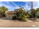 Well-maintained home with lush landscaping, a three-car garage, and meticulously maintained desert landscaping at 8737 E San Vicente Dr, Scottsdale, AZ 85258