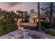 Beautiful single-Gathering home showcasing desert landscaping, exterior lighting, and a covered front entrance at 8737 E San Vicente Dr, Scottsdale, AZ 85258