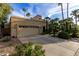 Three-car garage exterior showcasing desert landscaping and a meticulously maintained front yard at 8737 E San Vicente Dr, Scottsdale, AZ 85258