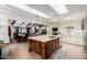 Spacious kitchen and dining area featuring custom island, countertops and stainless appliances at 8737 E San Vicente Dr, Scottsdale, AZ 85258