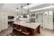 Bright open kitchen features stainless appliances, breakfast bar, and custom cabinetry at 8737 E San Vicente Dr, Scottsdale, AZ 85258